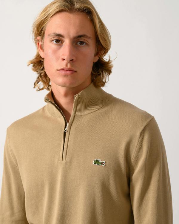 close up of model wearing a Lacoste Half Zip Logo Mens Sweatshirt in Cookie SIX