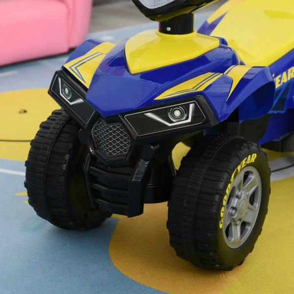 Close-up of blue and yellow ride-on quad bike front with LED headlights and chunky tires