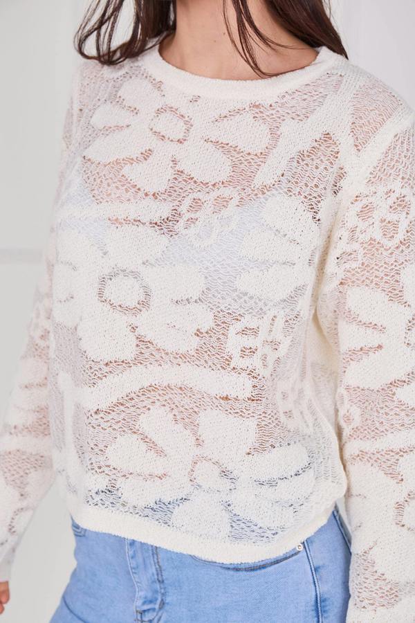 Model wearing a long sleeve crochet top with an open-knit pattern, styled with high-waisted jeans, featuring a relaxed fit and lightweight texture for casual everyday wear.