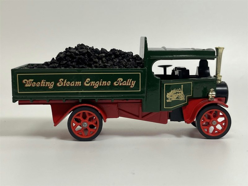 a toy truck with coal in the back