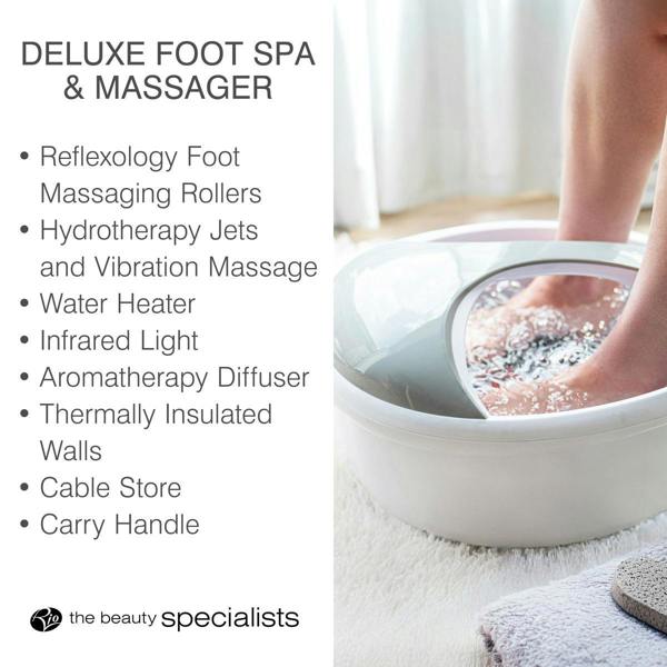 A person enjoys a Rio Deluxe Foot Spa Bath and Massager, featuring rollers, jets, water heater, infrared light, aromatherapy, insulated walls, cable storage, and a carry handle.