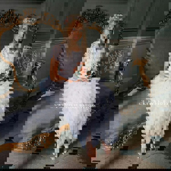 Girl wearing dress and holding flower bouquet