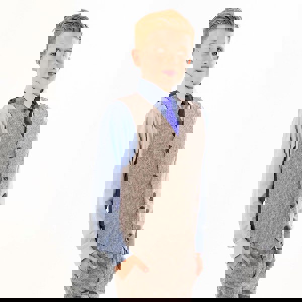 Boy wearing a tweed waistcoat and blue shirt