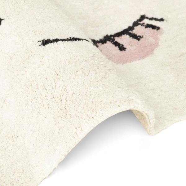 Close-up of a textured rug with a heart design on a light background