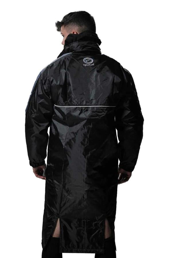 Man wearing long black Optimum sideline sub jacket, back view with reflective piping, on white - Optimum