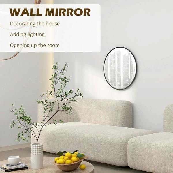 Round black wall mirror with thin frame hanging on a wall near a sofa