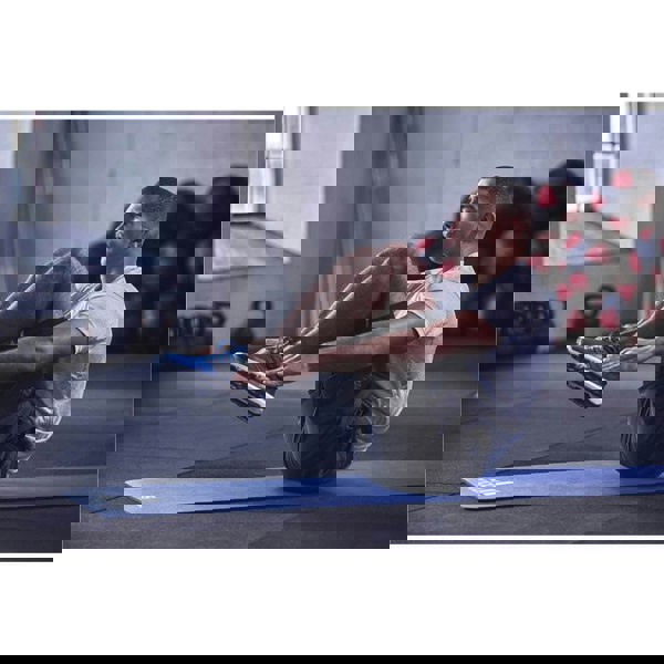 Man exercising in the gym on an Adidas 7mm Training Mat - Blue