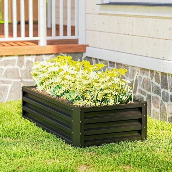 Outdoor raised planter with slatted sides, planted with green herbs and yellow blooms