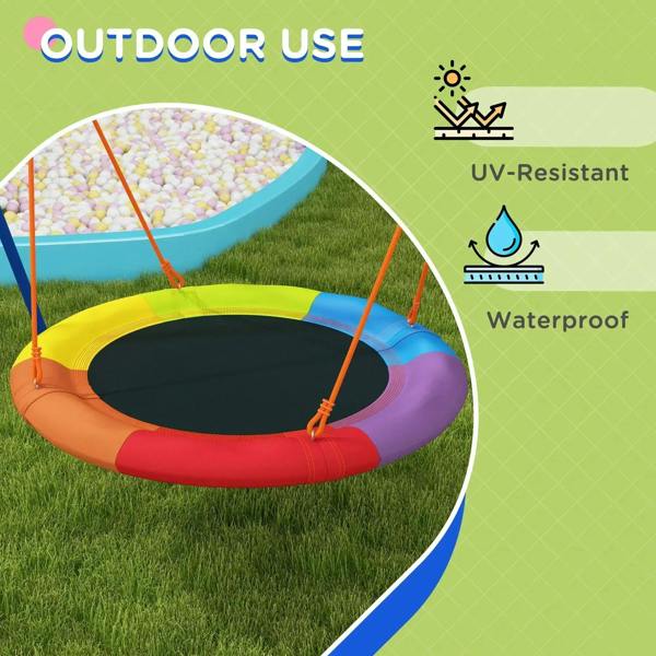 Round nest swing seat with multicolor padding and orange ropes on grass