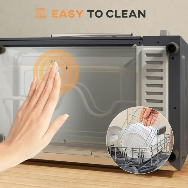 Grey mini oven interior being cleaned with cloth; wire rack and tray inside.