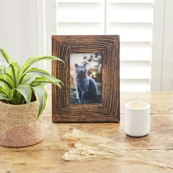 Natural Mango Wood Photo Frames with flowers on a shelf.