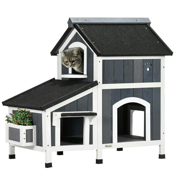 Grey wooden cat house with flower pot, arched doorways, windows, two levels