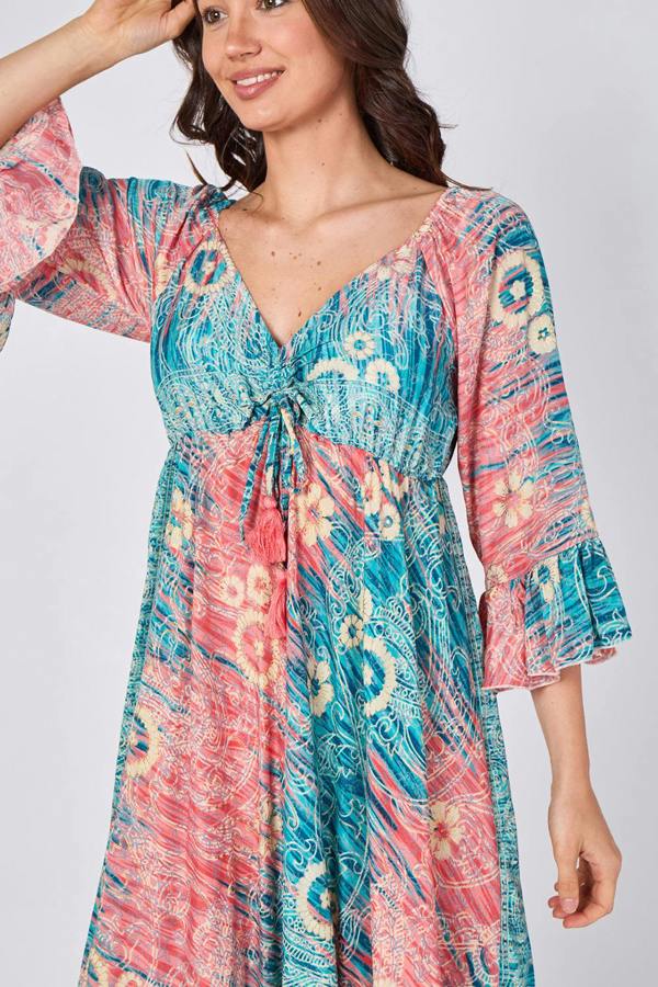 Woman wearing a colorful patterned dress on a white background