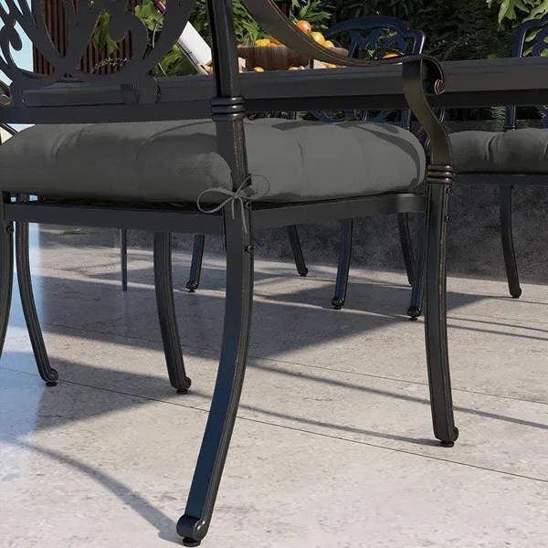 Charcoal gray seat cushion with ties, padded quilted square on outdoor chair