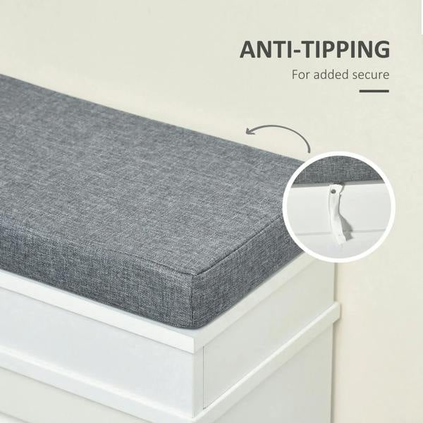 Gray upholstered seat cushion on white shoe storage bench with anti-tip mounting hardware