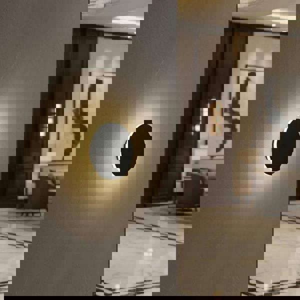 Modern black wall sconce in  a hotel foyer