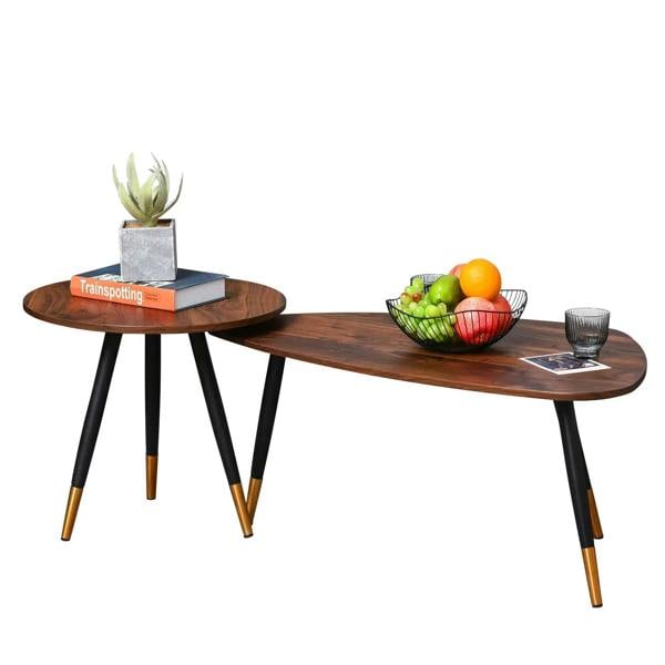 Set of two walnut round coffee tables with black tapered legs and gold feet