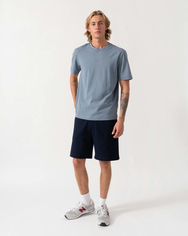 Model wearing the Lacoste Regular Fit Mens Fleece Shorts - Blue Marine 166