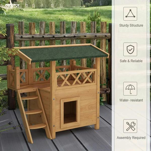 Outdoor wooden cat house with green roof, raised base, balcony railing, and square door