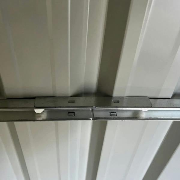 Grey metal shed floor foundation frame with cross braces under the base