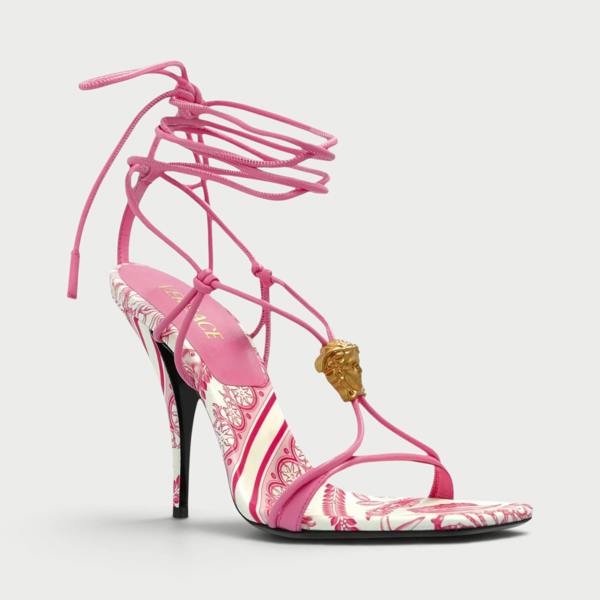 Supplied Fashion pink and white Medusa Barocco square-toe heeled sandals with gold hardware and lace-up ankle straps.