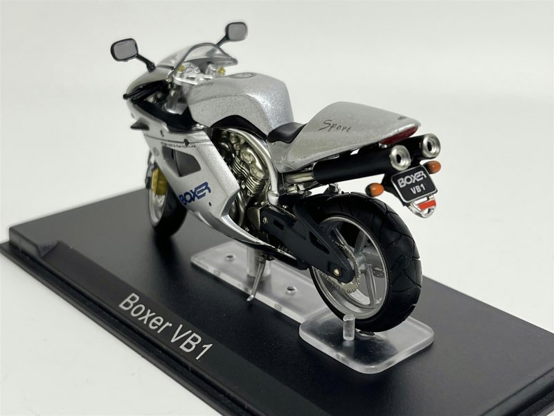 a silver motorcycle on a black stand