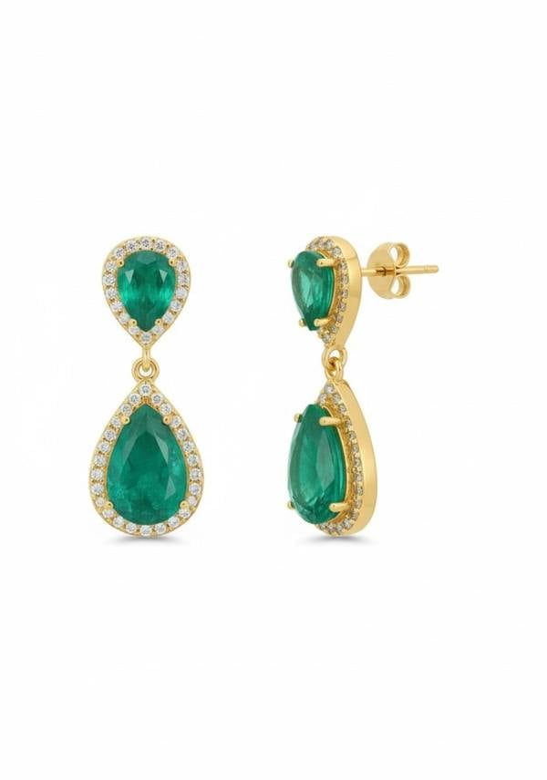 Gold earrings with green gemstones on a white background