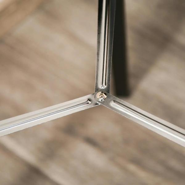 Close-up of chrome tripod joint with metal brace and screws