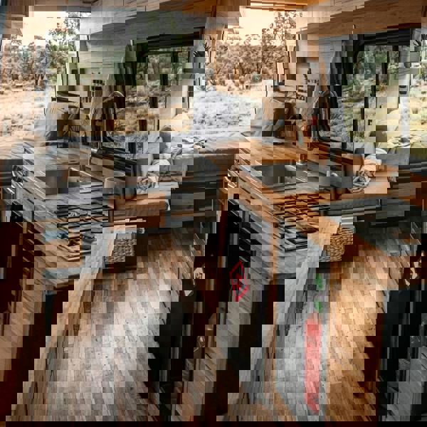 Stylish gas bottle locker for 6kg bottles, featuring a sleek design, wooden cabinetry, and a modern kitchen setup in a camper van