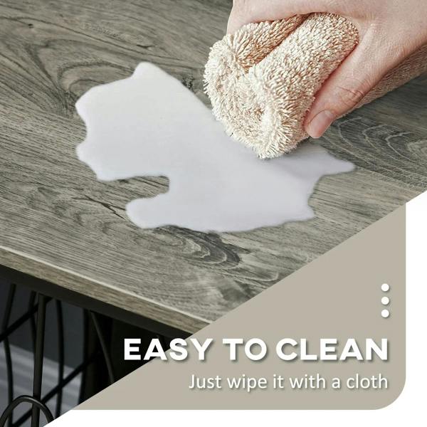 Grey dog crate end table top being wiped clean with a cloth for easy cleaning
