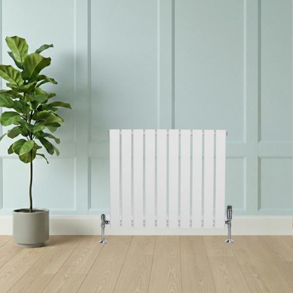 Flat single column radiator in white, 600 x 700mm, featuring sleek vertical panels and chrome valve accents, set against a light wall and wooden floor