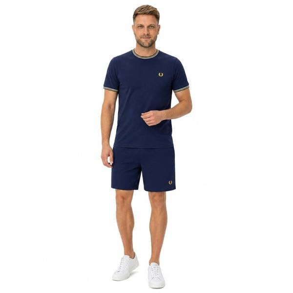 Fred Perry French Navy swim shorts and matching t-shirt with yellow and white trim, worn by a man.