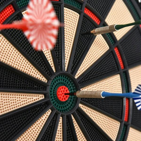 Close-up of dartboard bullseye with two darts landing in the target rings