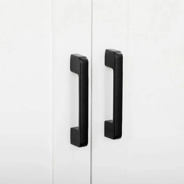 White cabinet doors with two black bar handles on the front panel.