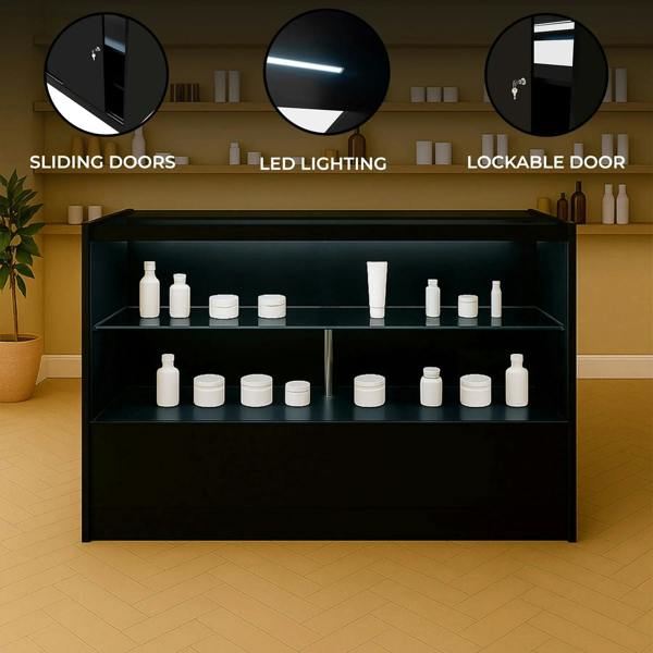 Black LED retail shop counter C1500 with sliding doors, lockable door, and illuminated shelves displaying white cosmetic containers