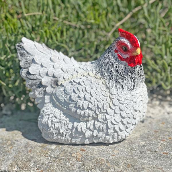 A detailed, lifelike ornament of a white chicken
