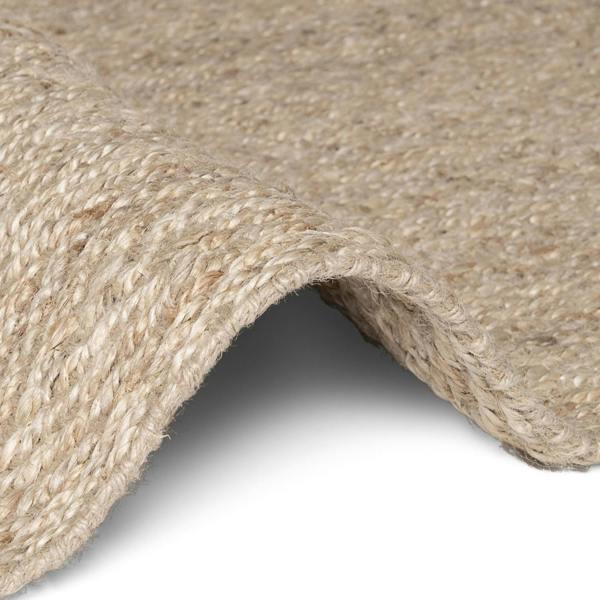 Close-up of a textured beige fabric with a white background