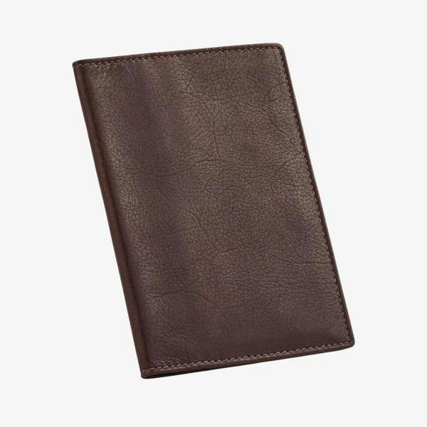 Brown leather passport holder on a white background