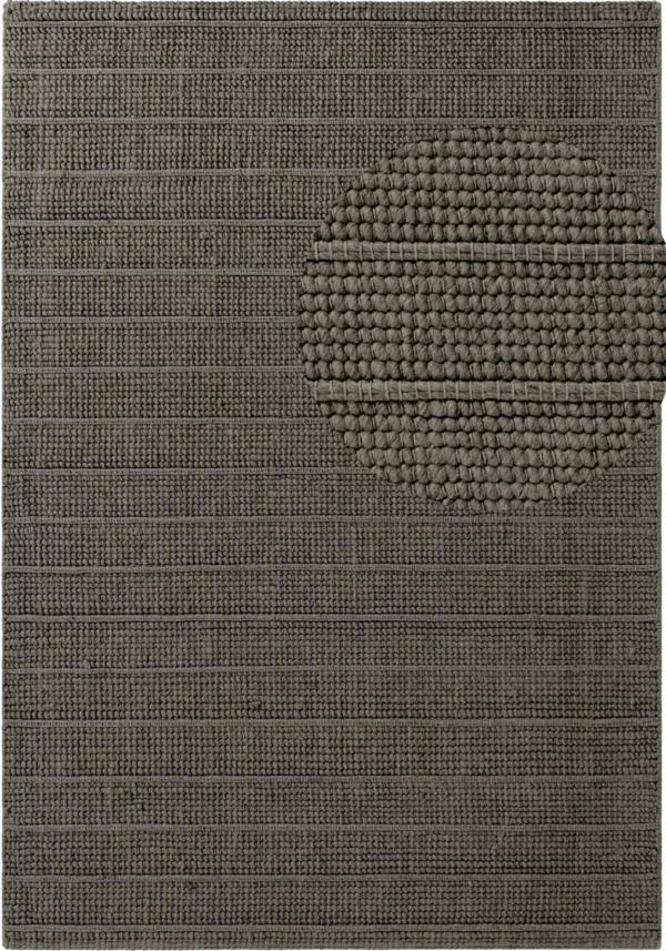 Textured brown rug with a circular pattern
