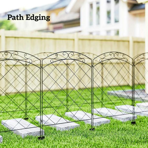 Black steel fence panels edging a path with arched swirled tops and diamond grid mesh