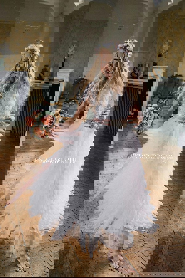 Girl dancing in large room wearing flower girl dress