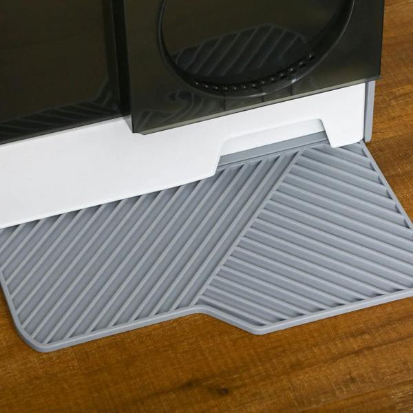 Close-up of grey ribbed base mat under the front entrance of an enclosed cat litter box.