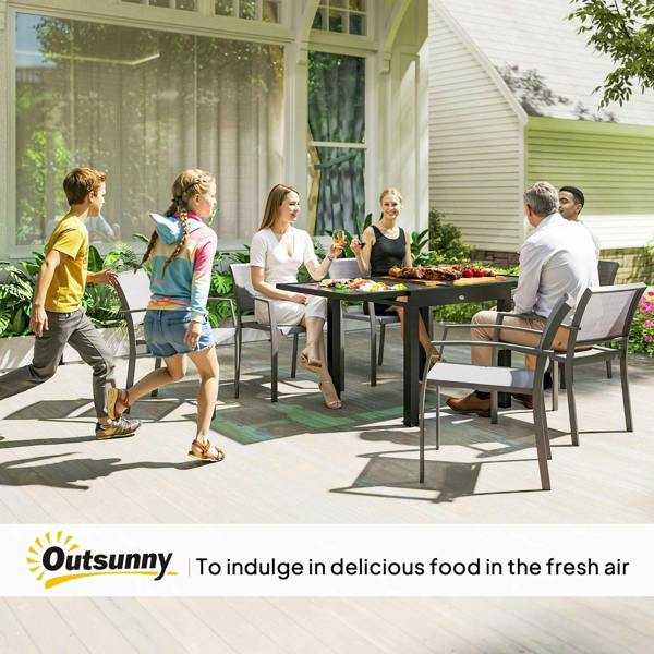 Family dining outdoors with black extendable table and clear tempered glass tabletop