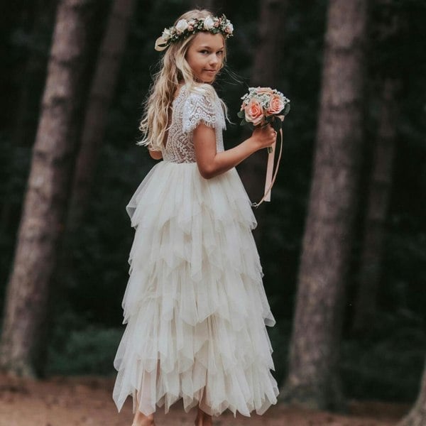 Beautiful young girl wearing dress holding bouquet