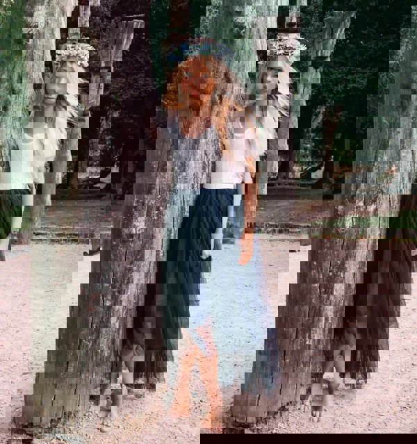 young girl wearing a navy blue flower girl dress