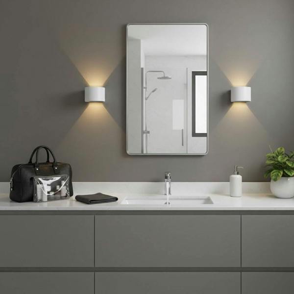 white wall mounted bathroom light fitted either side of a bathroom mirror 