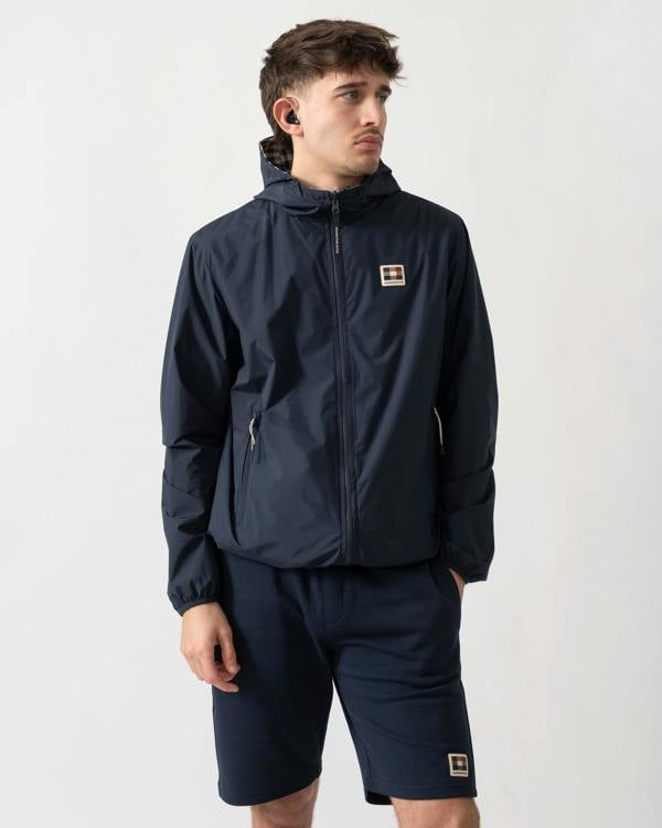 studio shot of a model wearing an Aquascutum Mens RLG Badge Reversible Sailor Jacket in Navy 11