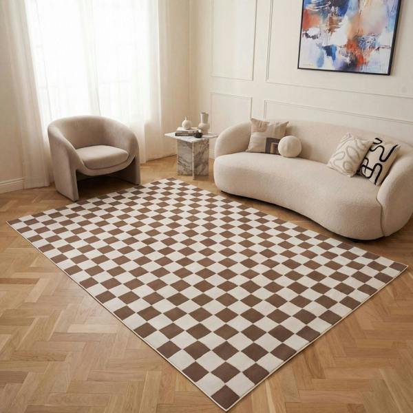 Living room with a checkered rug, beige sofa, and armchair.