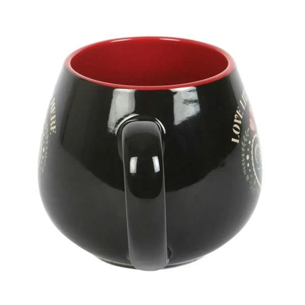 Black ceramic mug with red interior rim and matching handle, rounded body