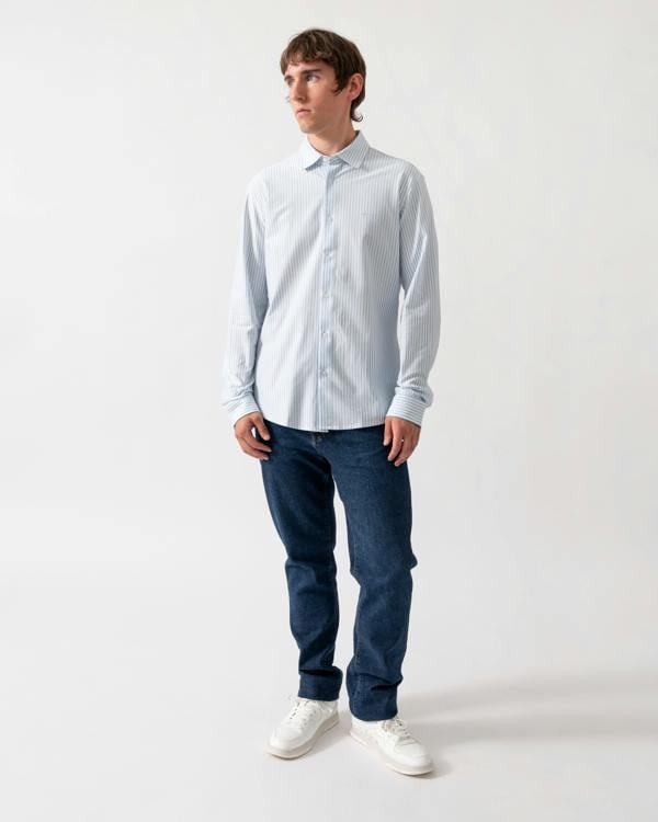 full length of a model wearing a BOSS Orange Mysoft Mens Slim-Fit Shirt in Melange Cotton Jersey in Open Blue 461